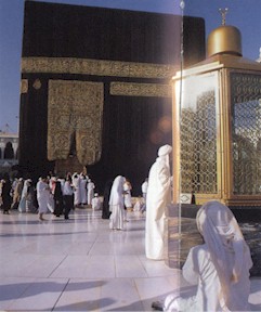 Holy Kaba in background and the Maqam Ibrahim in foreground, the Maqam contains the footprints of Prophet Ibraham. Following the Quran, pilgrims offer two rakat prayers here. (source - Tell me about Hajj)